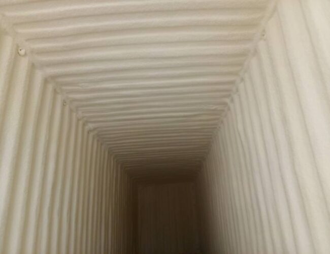 Interior of a shipping container insulated with spray foam.