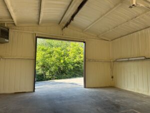 Open Warehouse With Spray Foam Insulation On The Walls And Ceiling.